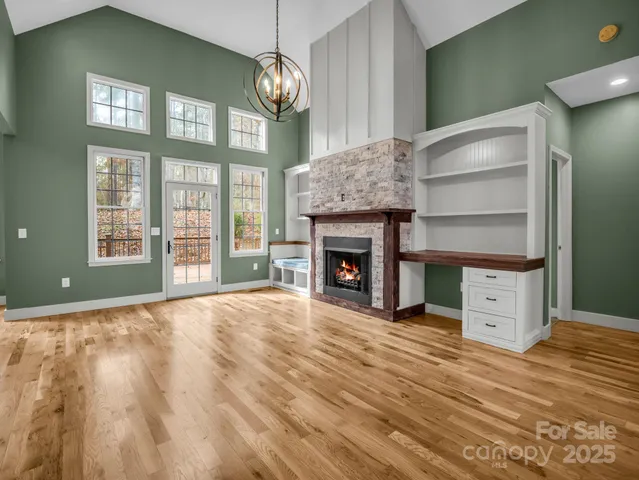 a view of an empty room with a fireplace and a window