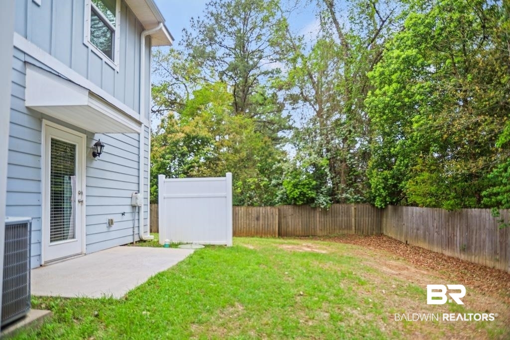 25806 Pollard Road, Unit 27 Daphne, AL 36526 - Photo 13 of 46 Fenced backyard with a patio area