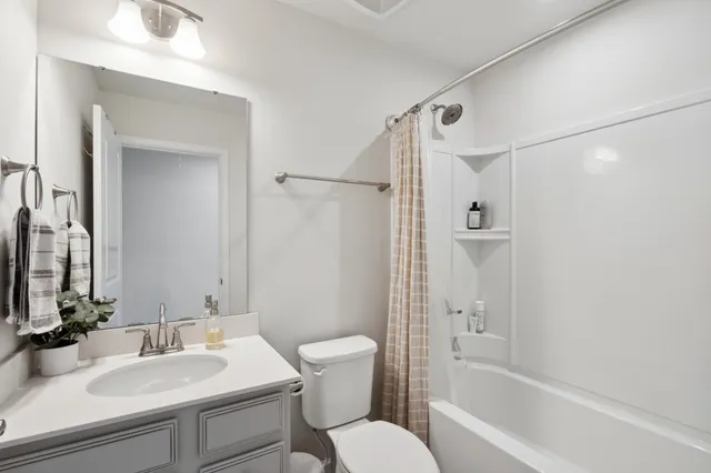 a bathroom with a sink toilet tub and shower