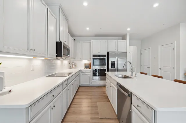 a large kitchen with stainless steel appliances lots of counter space sink and cabinets