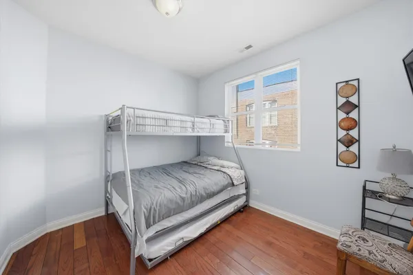 a view of a livingroom with wooden floor and a window