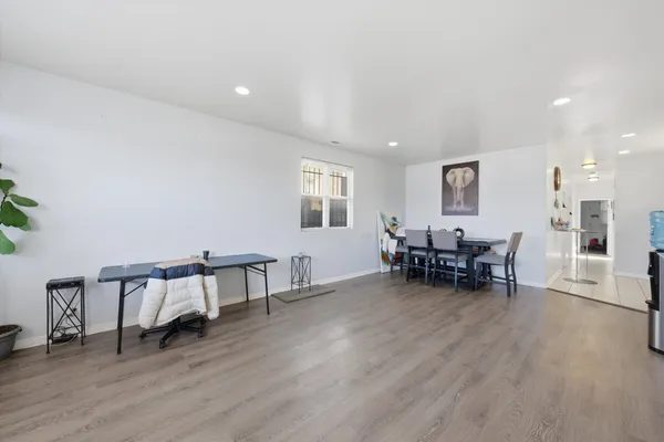 a view of a house with a yard and parking space