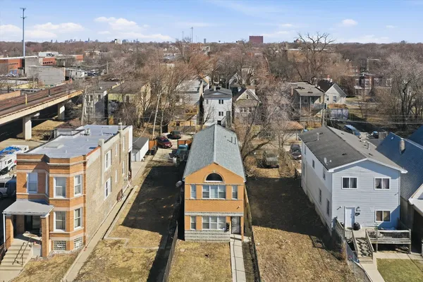 an aerial view of a residential building with parking space