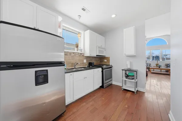 a kitchen with a refrigerator and a stove