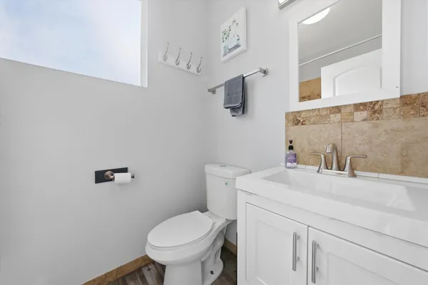 a bathroom with a sink a toilet and mirror