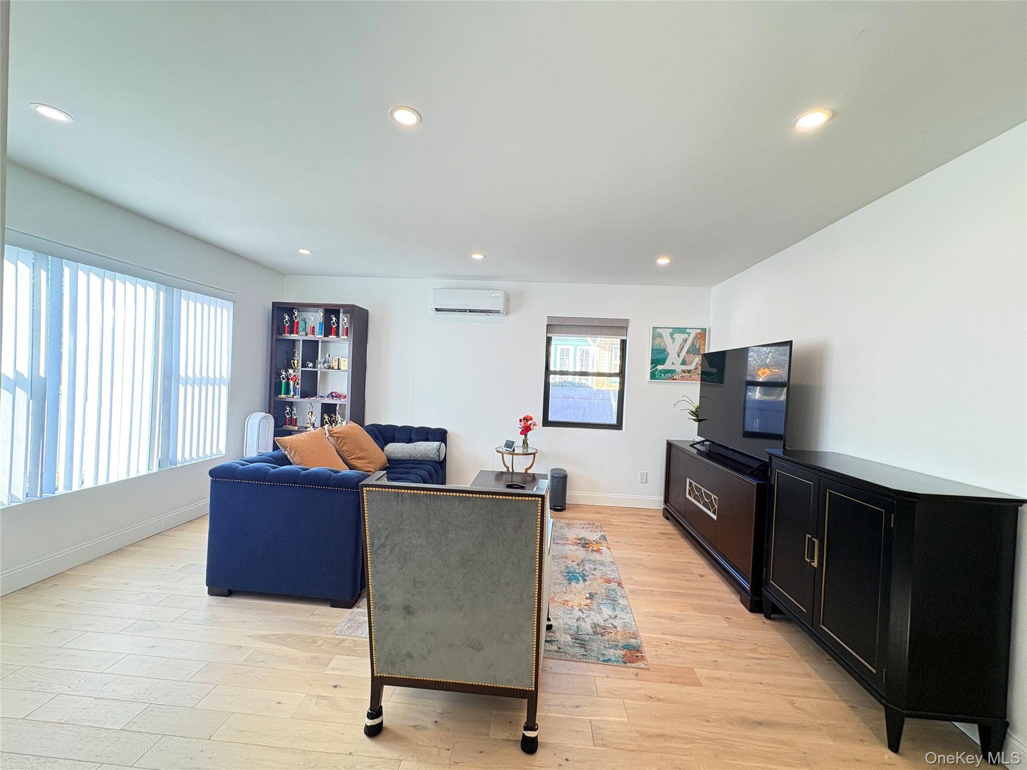 41-75 Morgan Street Queens, NY 11363 - Photo 1 of 50 a living room with furniture and a flat screen tv