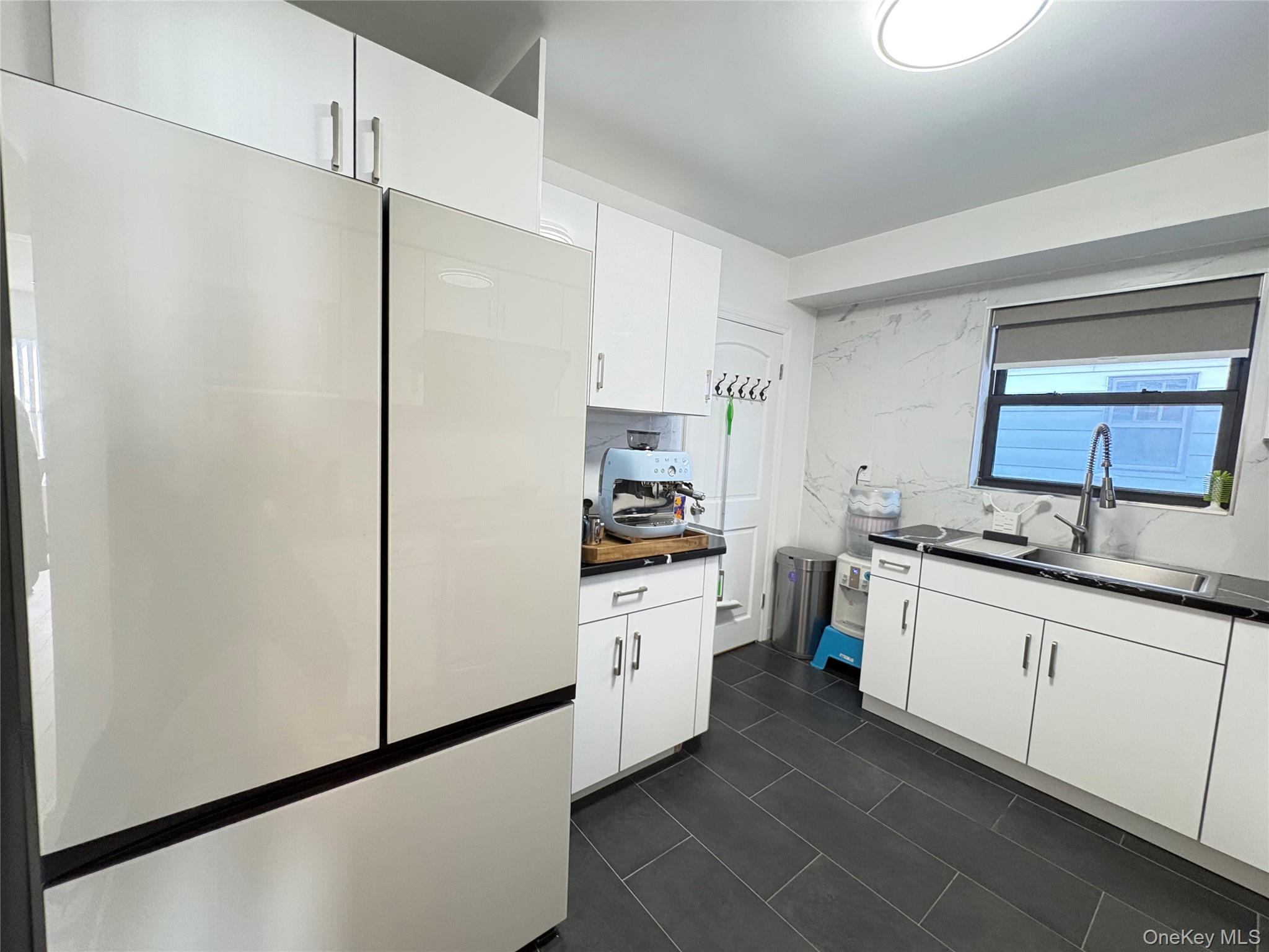 41-75 Morgan Street Queens, NY 11363 - Photo 11 of 50 a kitchen with stainless steel appliances a sink cabinets and a refrigerator