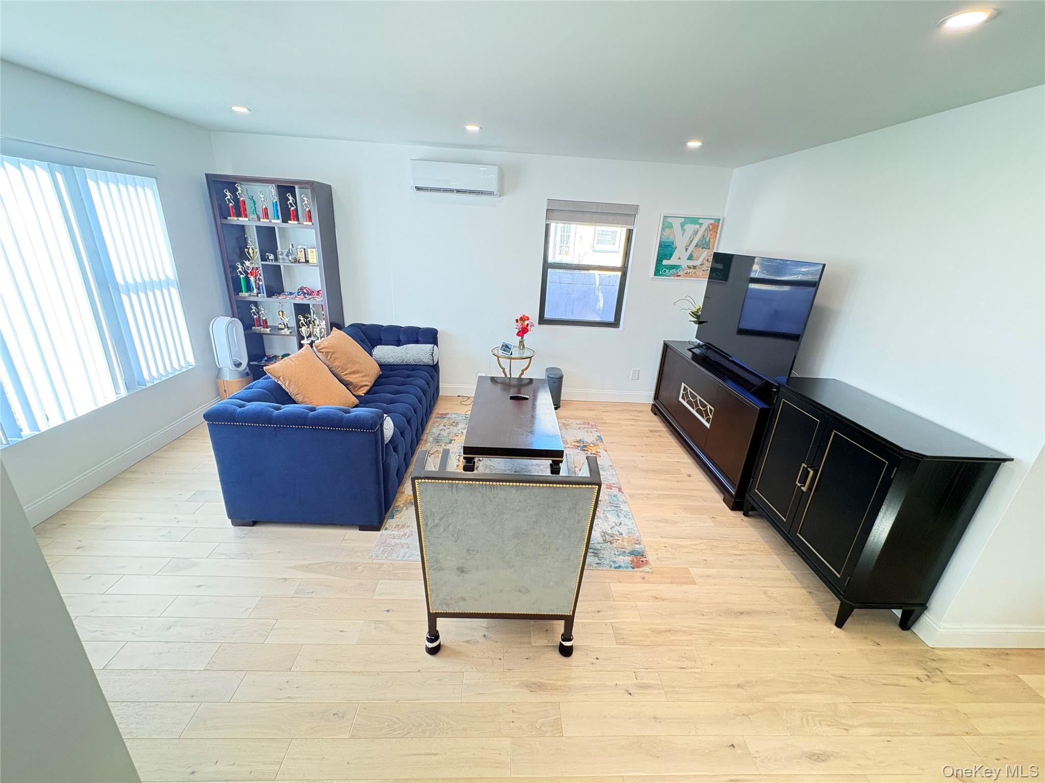 41-75 Morgan Street Queens, NY 11363 - Photo 2 of 50 a living room with furniture and a flat screen tv