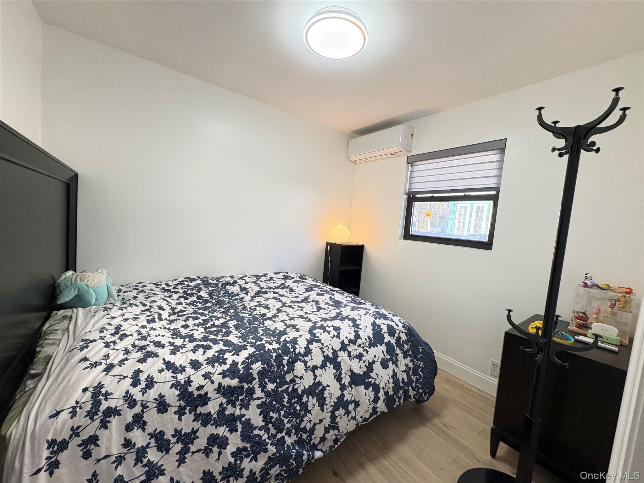 41-75 Morgan Street Queens, NY 11363 - Photo 24 of 50 a bedroom with a bed and wooden floor