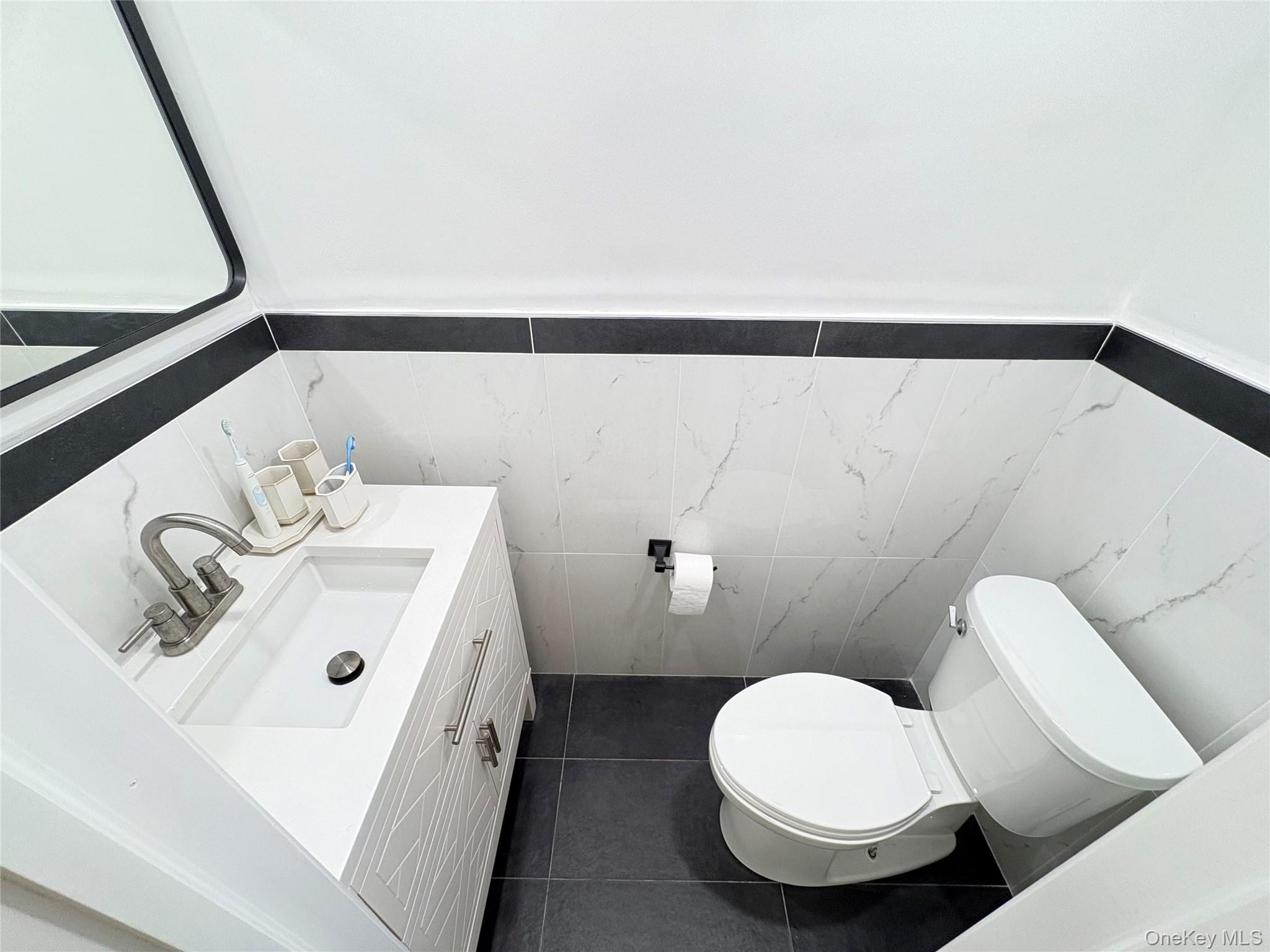 41-75 Morgan Street Queens, NY 11363 - Photo 27 of 50 a bathroom with a sink and a mirror