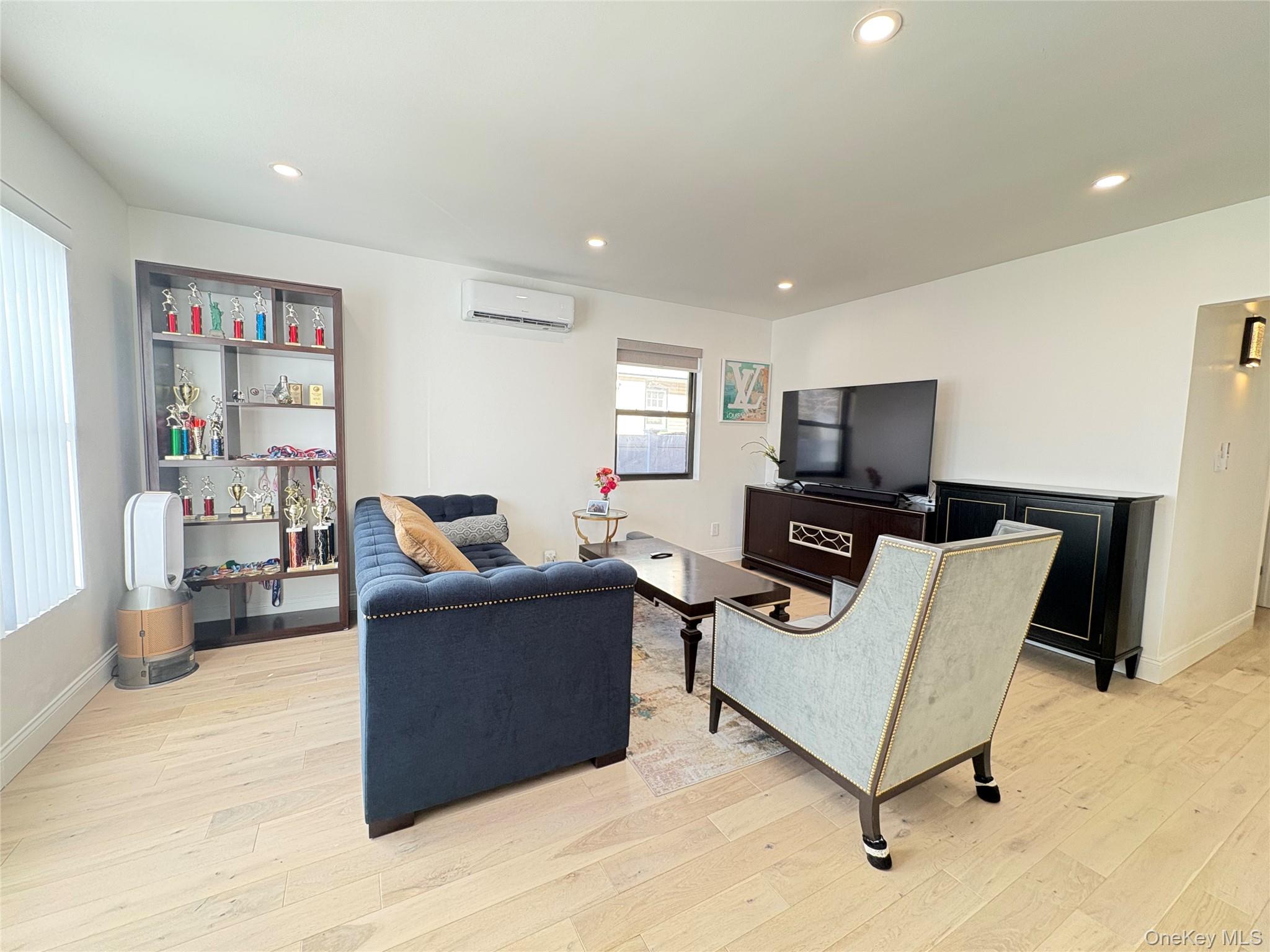 41-75 Morgan Street Queens, NY 11363 - Photo 3 of 50 a living room with furniture and a flat screen tv