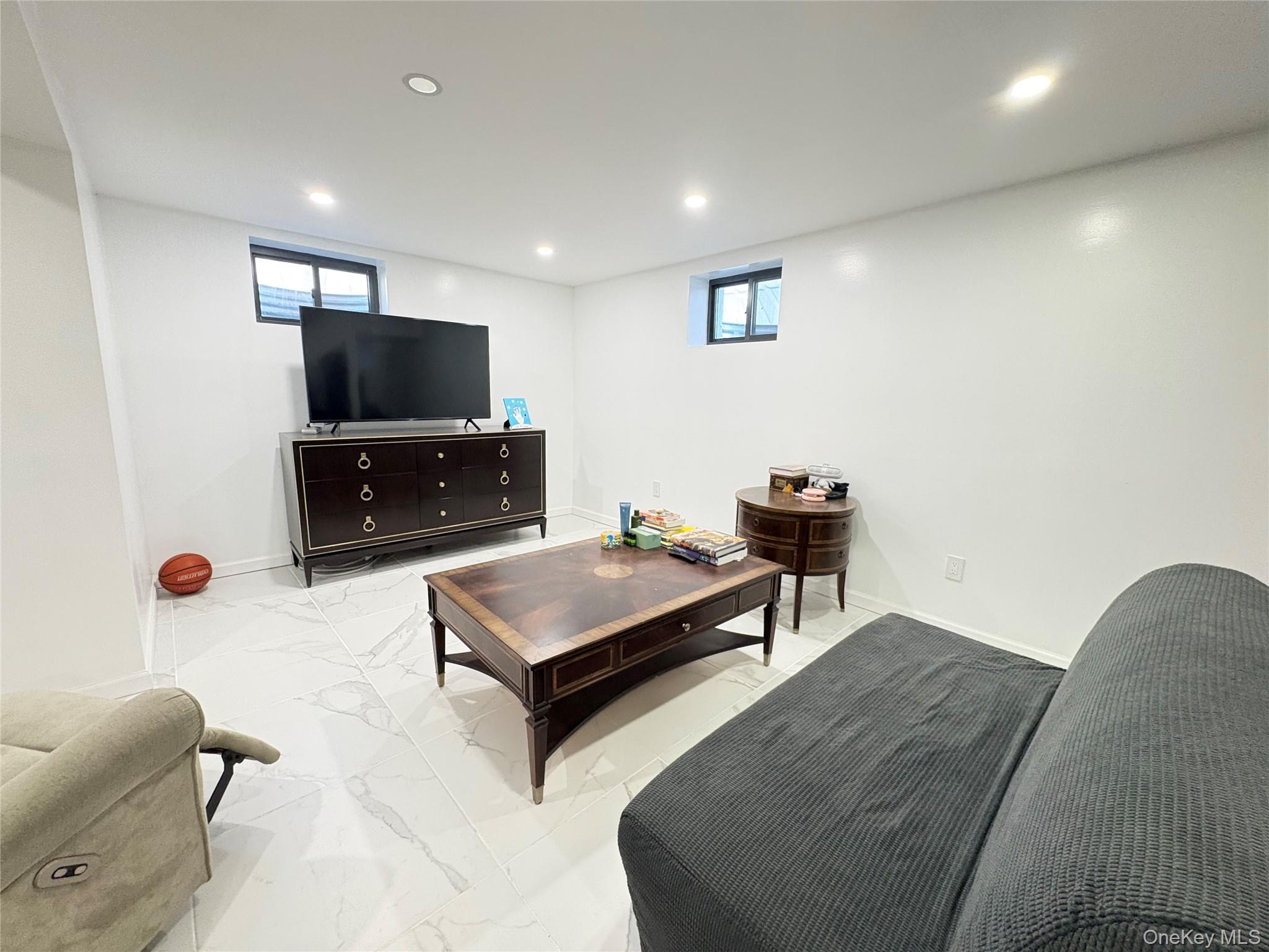 41-75 Morgan Street Queens, NY 11363 - Photo 33 of 50 a living room with furniture and a flat screen tv