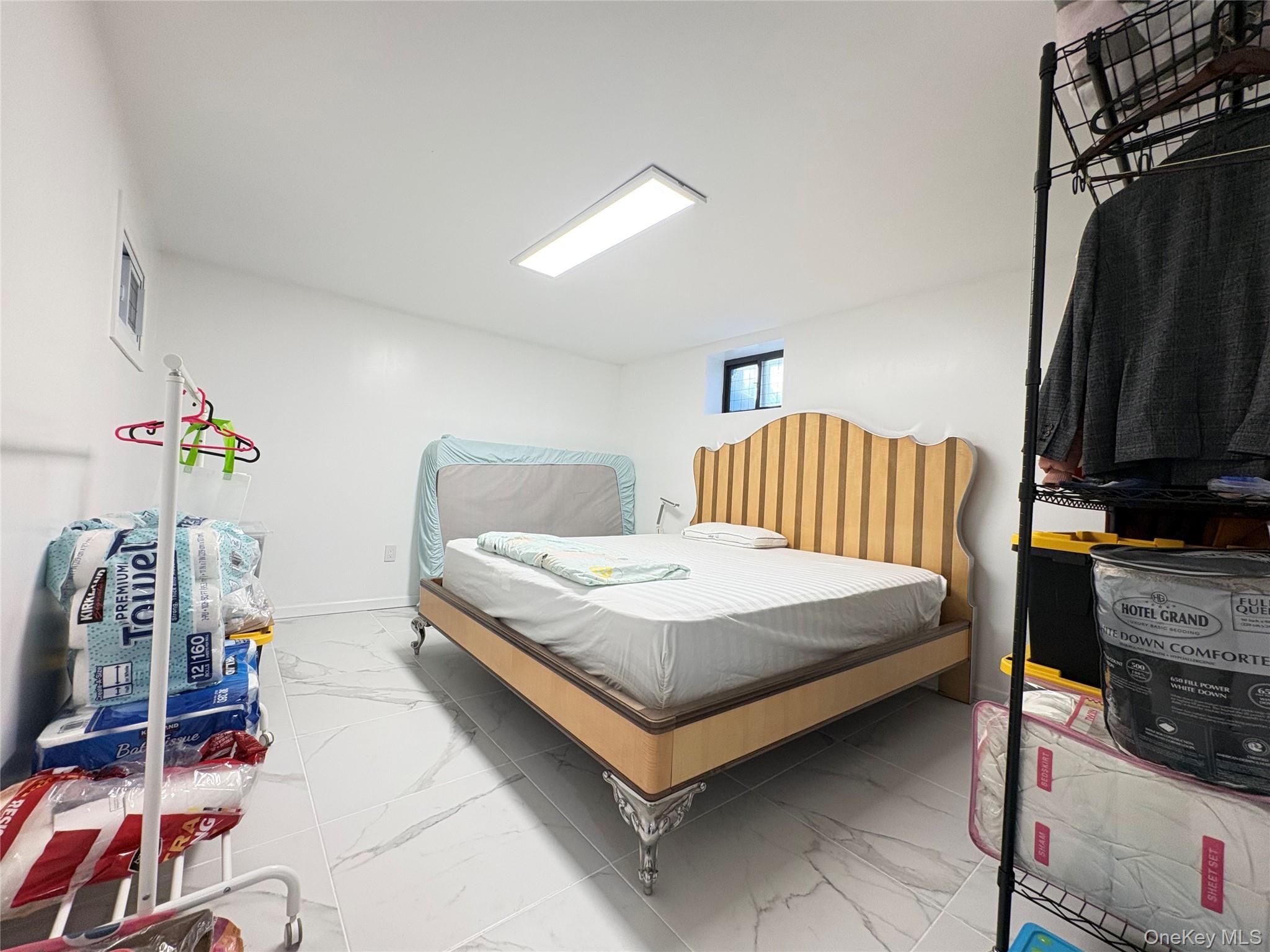 41-75 Morgan Street Queens, NY 11363 - Photo 35 of 50 a bedroom with a bed and a flat tv screen