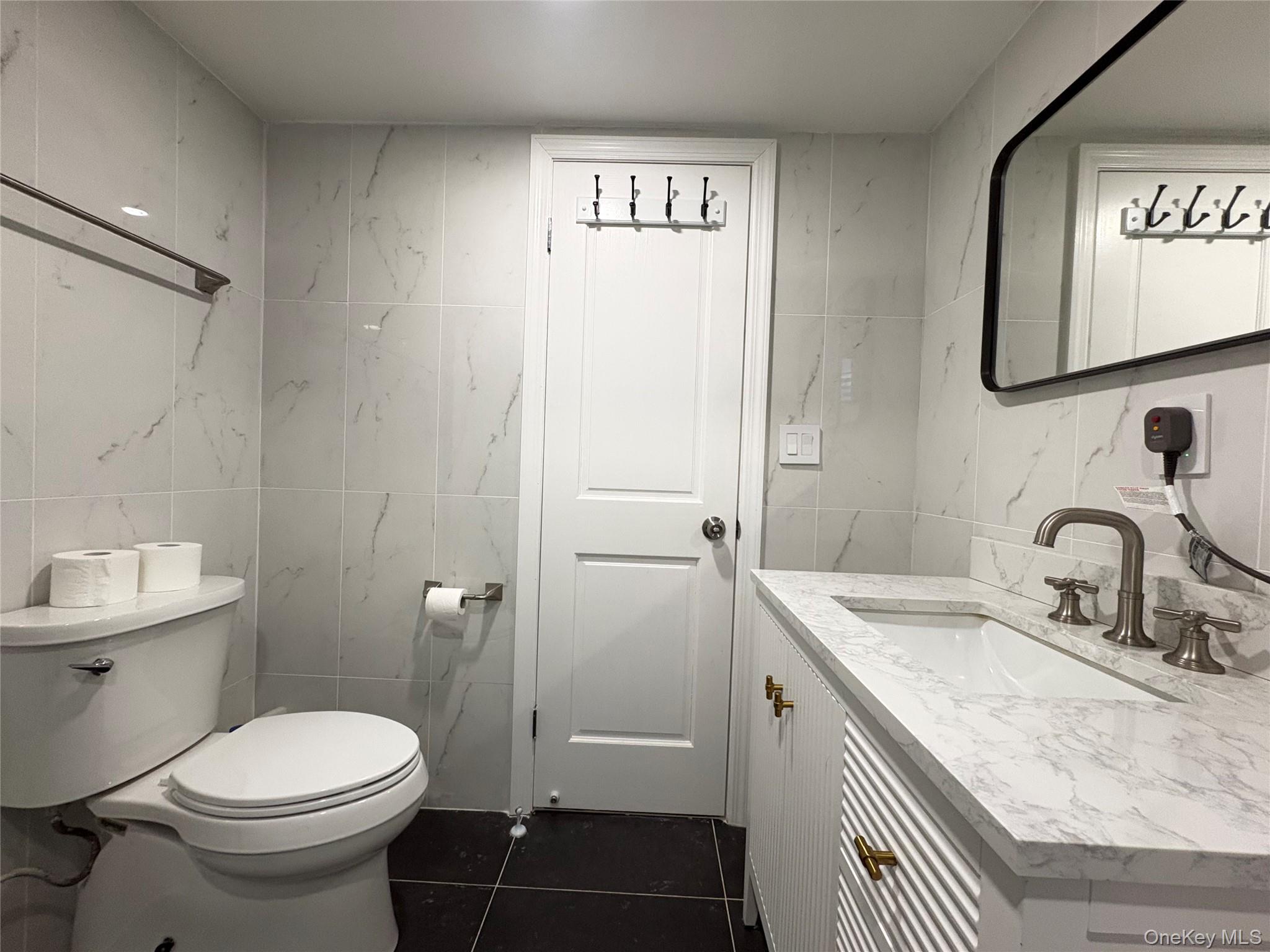 41-75 Morgan Street Queens, NY 11363 - Photo 38 of 50 a bathroom with a granite countertop sink toilet and shower