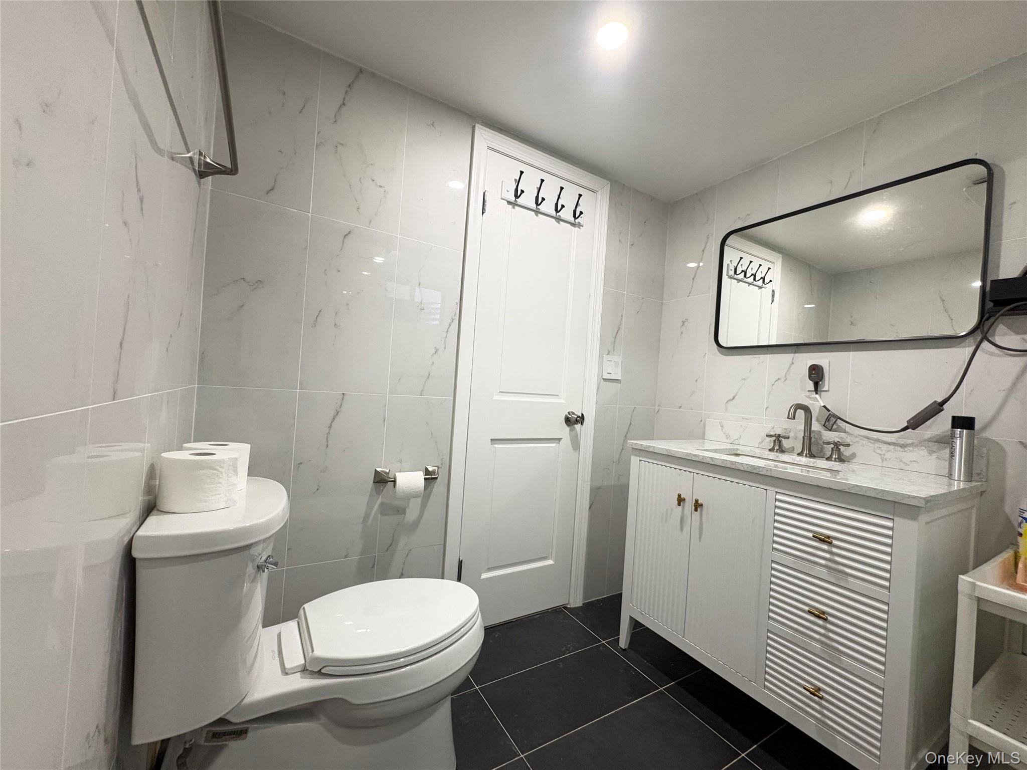 41-75 Morgan Street Queens, NY 11363 - Photo 39 of 50 a bathroom with a toilet sink and mirror