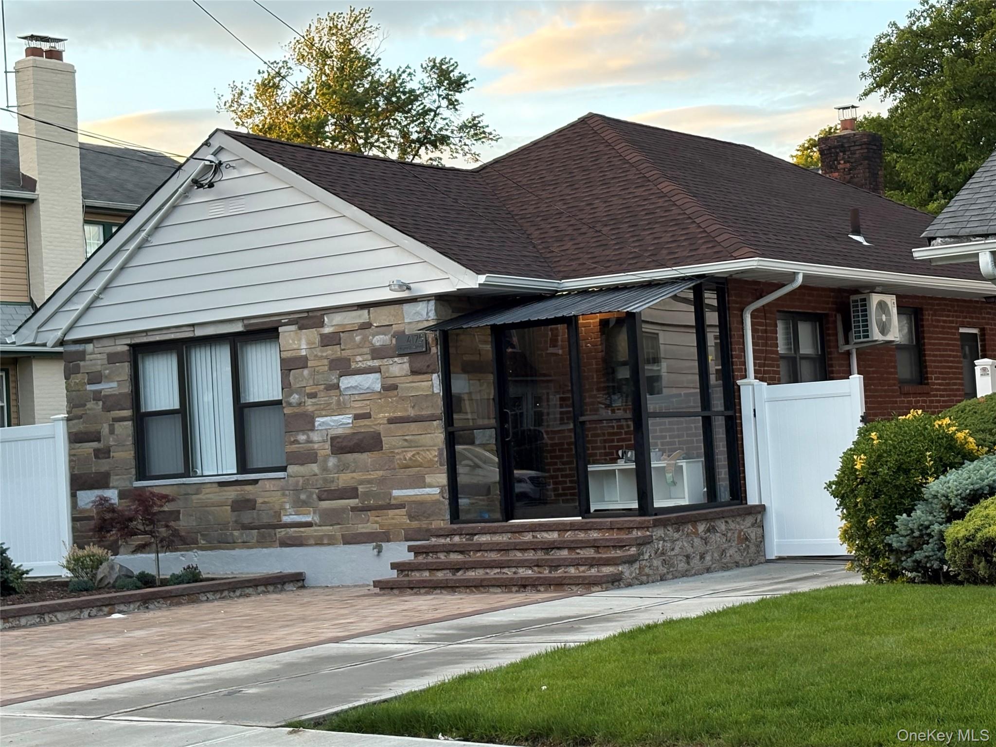 41-75 Morgan Street Queens, NY 11363 - Photo 41 of 50 a front view of a house with a garden