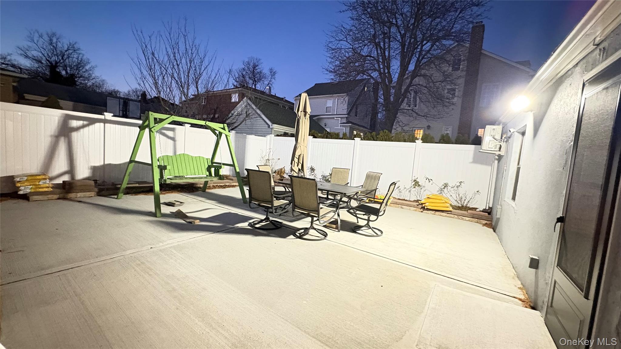 41-75 Morgan Street Queens, NY 11363 - Photo 45 of 50 a view of a patio with a table and chairs under an umbrella with a sink