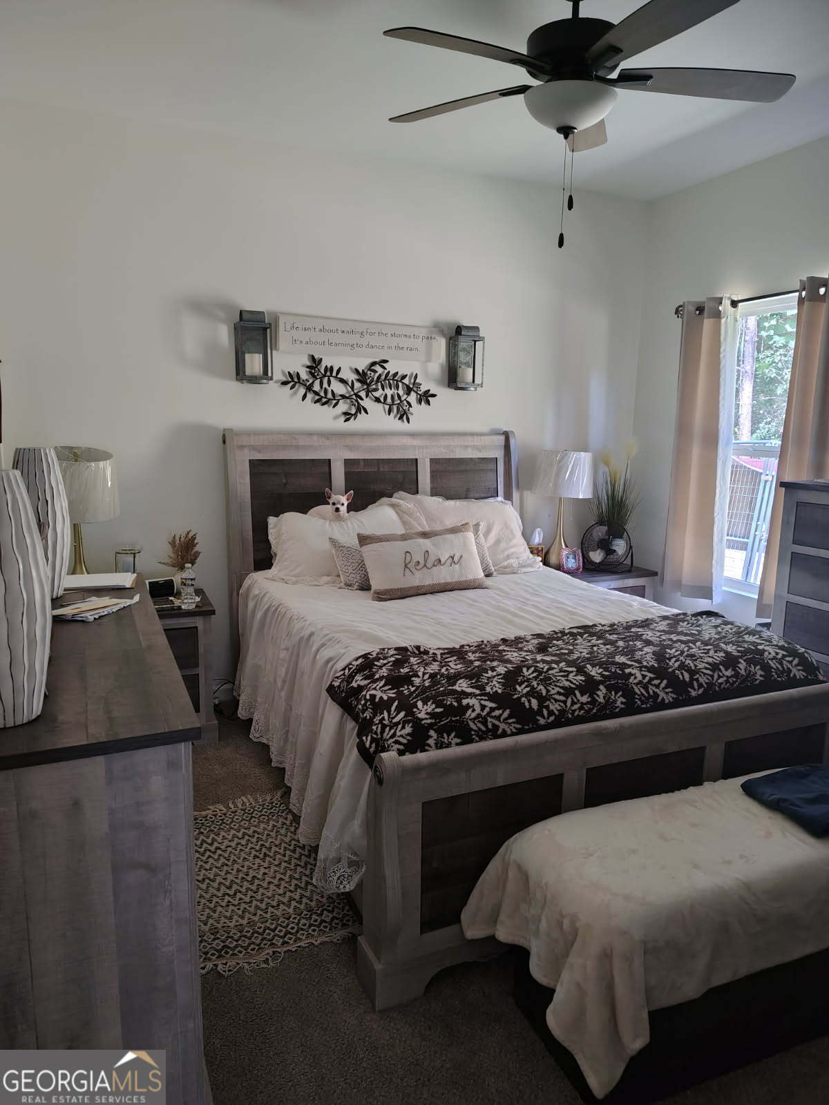 65 Magnolia Street Buchanan, GA 30113 - Photo 18 of 56 a bedroom with a large bed and a chandelier