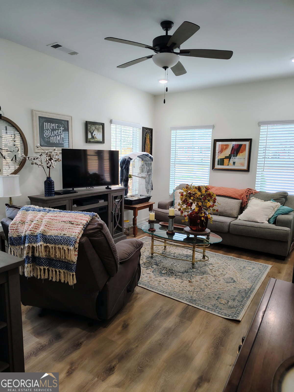 65 Magnolia Street Buchanan, GA 30113 - Photo 49 of 56 a bedroom with a bed a couch and a chandelier