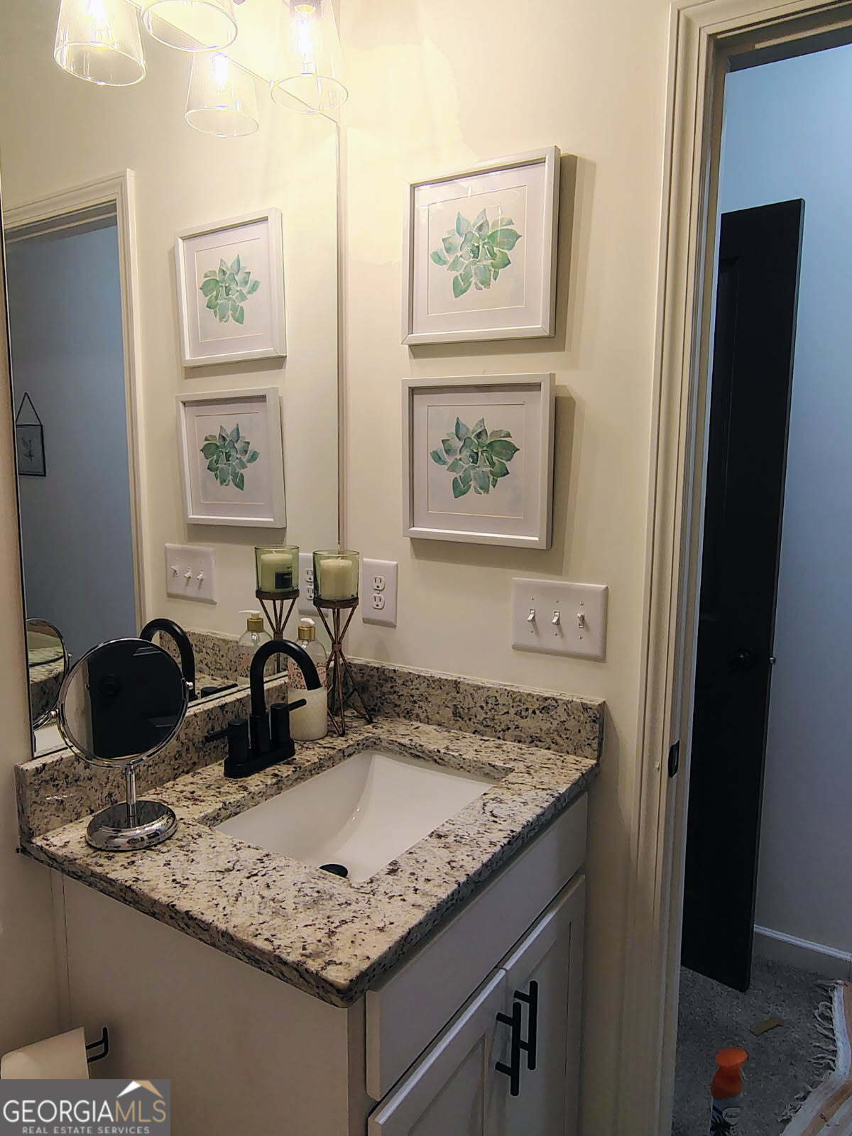 65 Magnolia Street Buchanan, GA 30113 - Photo 55 of 56 a bathroom with a granite countertop sink and a mirror