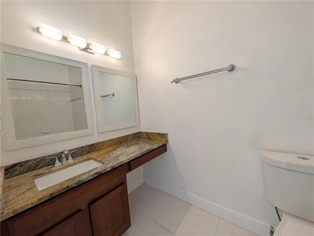 a white bath tub sitting next to a white toilet and a shower