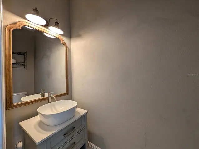 a kitchen with stainless steel appliances granite countertop a sink and a refrigerator