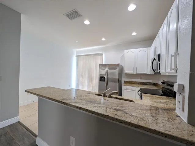 a kitchen with a stove top oven sink and cabinets