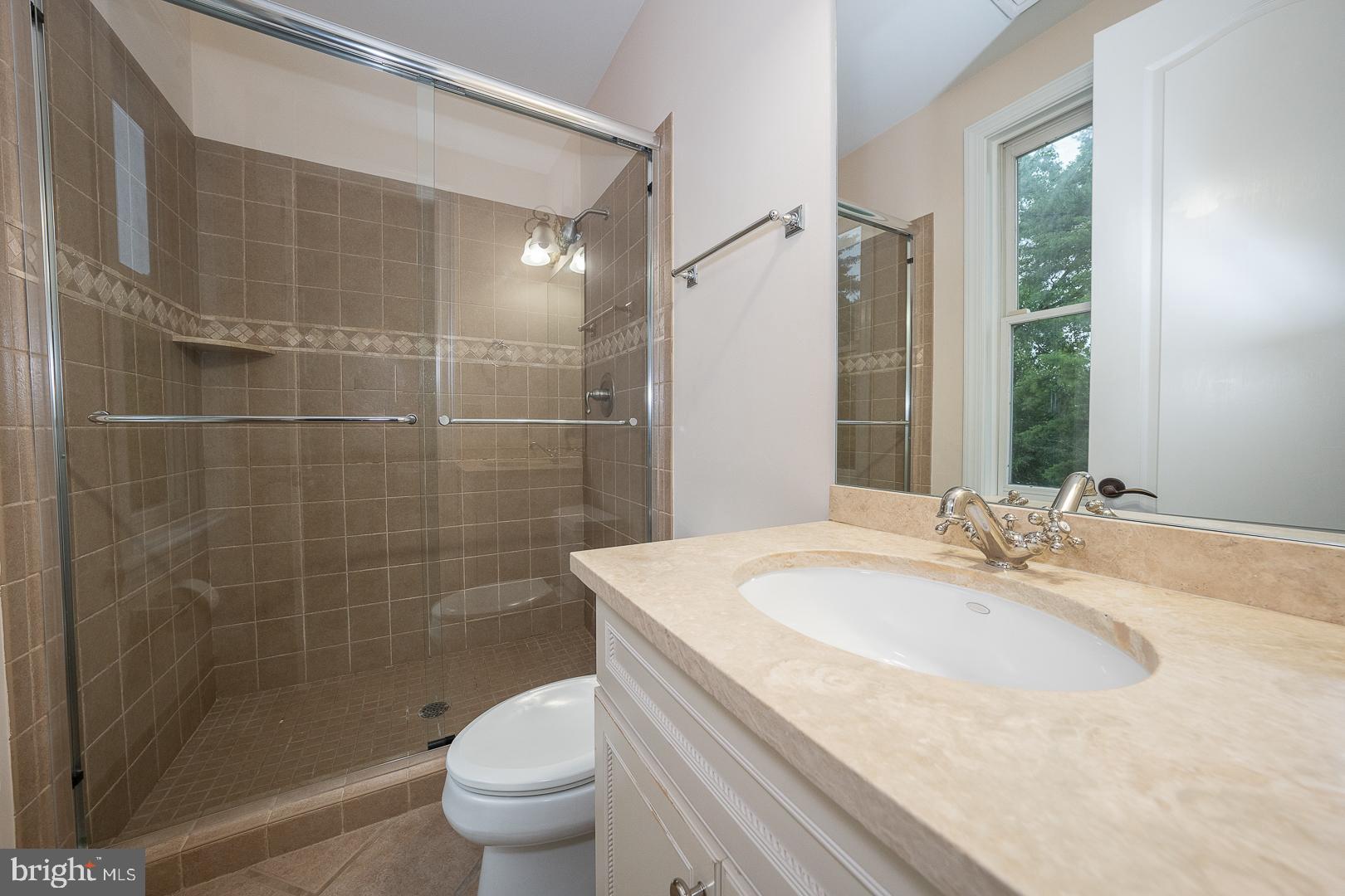 899 Black Rock Road Gladwyne, PA 19035 - Photo 33 of 59 a bathroom with a granite countertop sink a toilet and shower