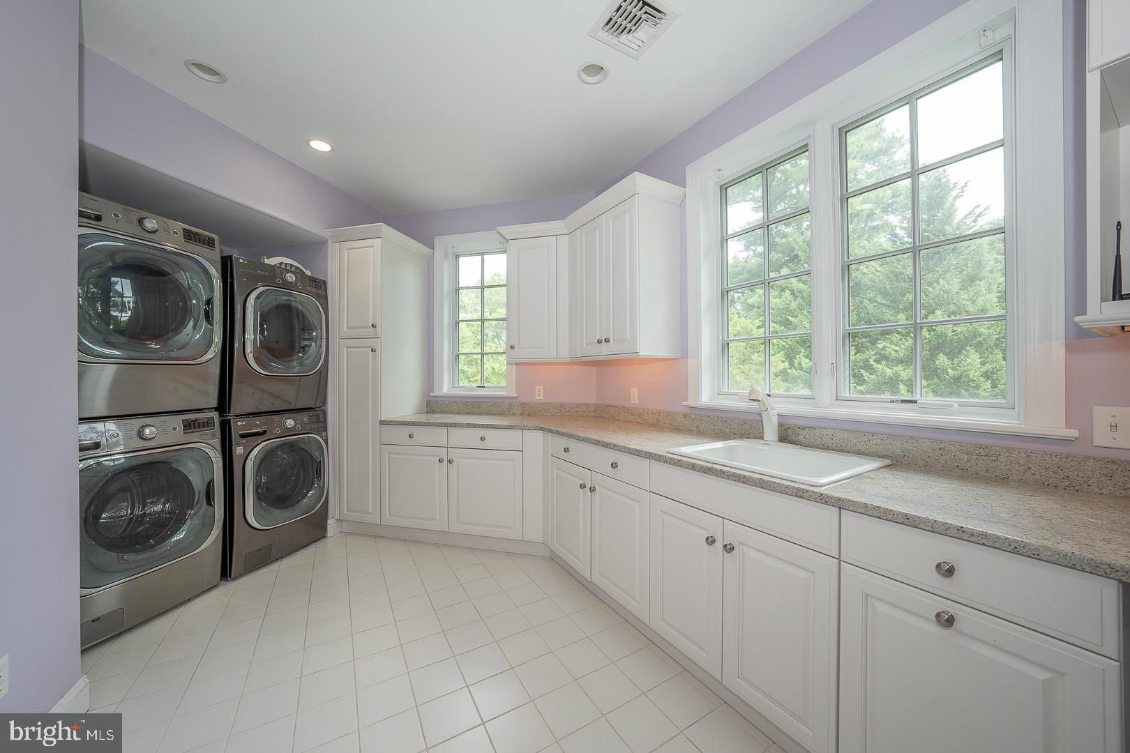 899 Black Rock Road Gladwyne, PA 19035 - Photo 41 of 59 a utility room with cabinets washing machine and a sink