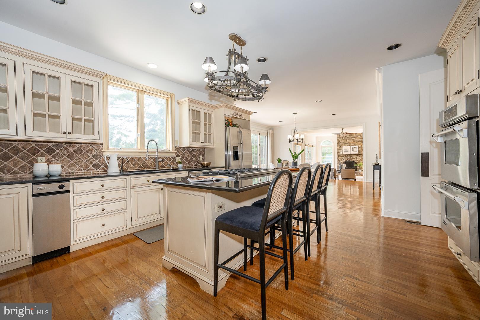 899 Black Rock Road Gladwyne, PA 19035 - Photo 5 of 59 a kitchen with stainless steel appliances granite countertop a dining table chairs sink and cabinets