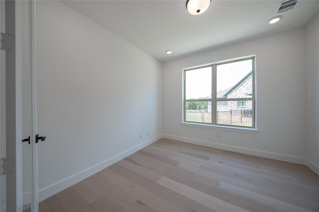 2719 Triumph Court Heath, TX 75126 - Photo 30 of 39 an empty room with wooden floor and windows