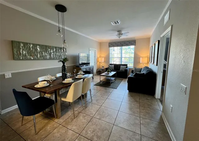 a living room with furniture a chandelier and a window