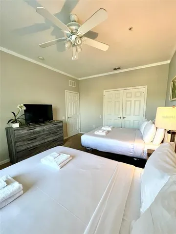a bedroom with a bed and a chandelier