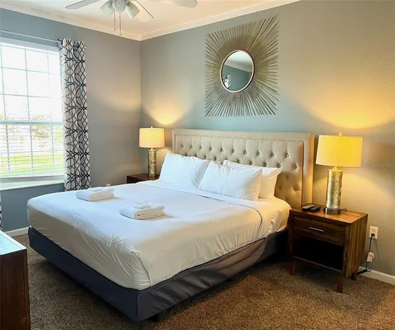 a bedroom with a bed and a chandelier