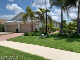 a front view of a house with a garden and yard