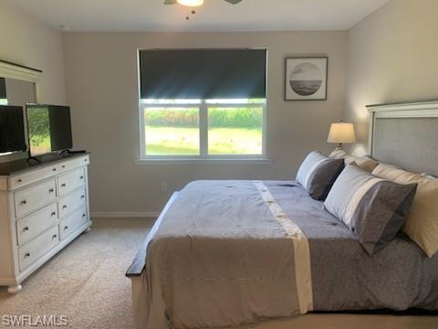 14631 Edgewater Circle Naples, FL 34114 - Photo 12 of 16 a bedroom with a bed and a flat tv screen on dresser