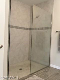 14631 Edgewater Circle Naples, FL 34114 - Photo 15 of 16 a bathroom with a glass shower door