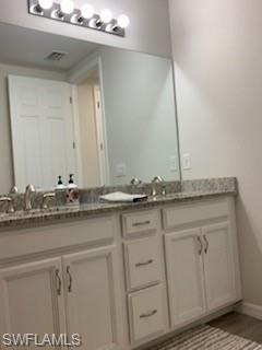 14631 Edgewater Circle Naples, FL 34114 - Photo 16 of 16 a bathroom with a sink and a mirror