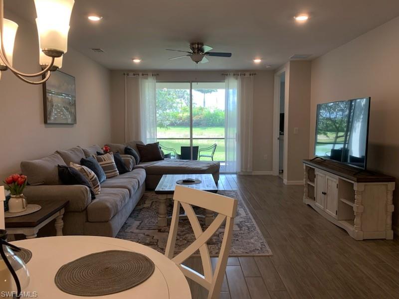 14631 Edgewater Circle Naples, FL 34114 - Photo 8 of 16 a living room with furniture and a window