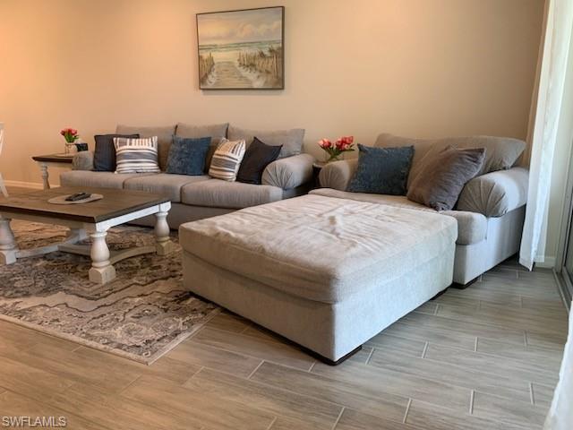 14631 Edgewater Circle Naples, FL 34114 - Photo 9 of 16 a living room with couches and painting on the wall