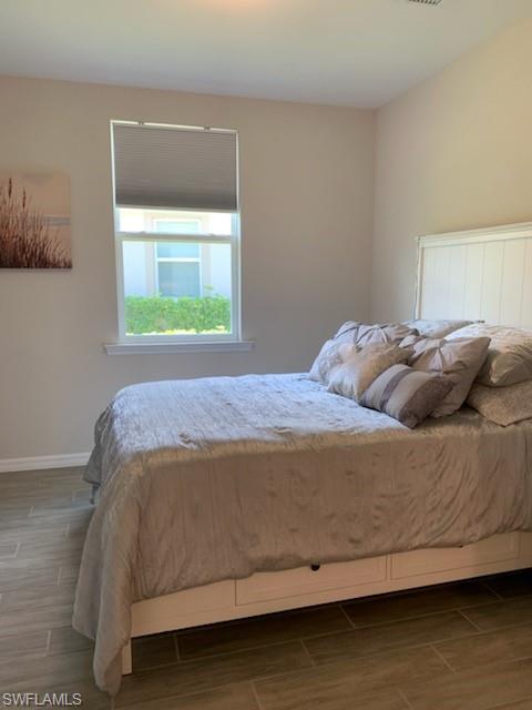 14631 Edgewater Circle Naples, FL 34114 - Photo 10 of 16 a bedroom with a bed and window