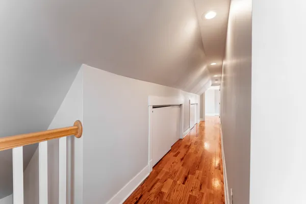 a view of a hallway with stairs