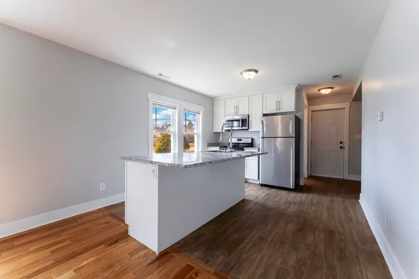 a kitchen with refrigerator and microwave