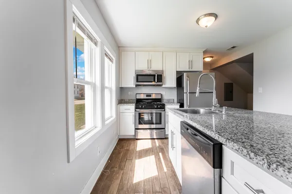 a kitchen with stainless steel appliances granite countertop a stove and a sink