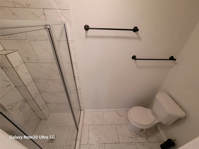 a bedroom with furniture and a large window