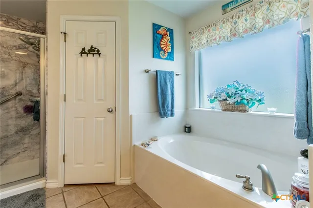 a bathroom with a tub and shower