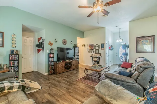 a living room with furniture and wooden floor