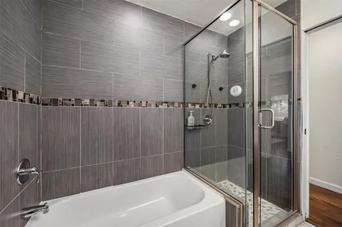 a bathroom with a bathtub and shower