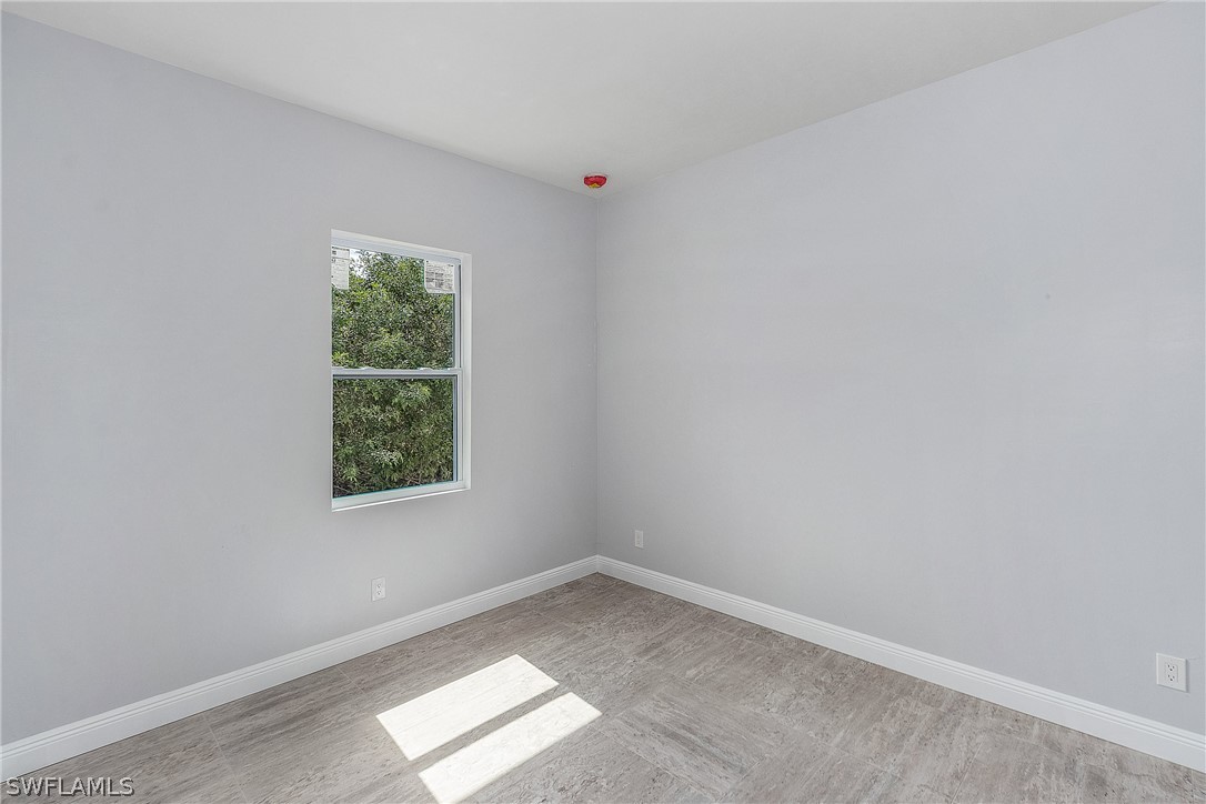 3196 Connecticut Avenue Naples, FL 34112 - Photo 14 of 18 an empty room with a window