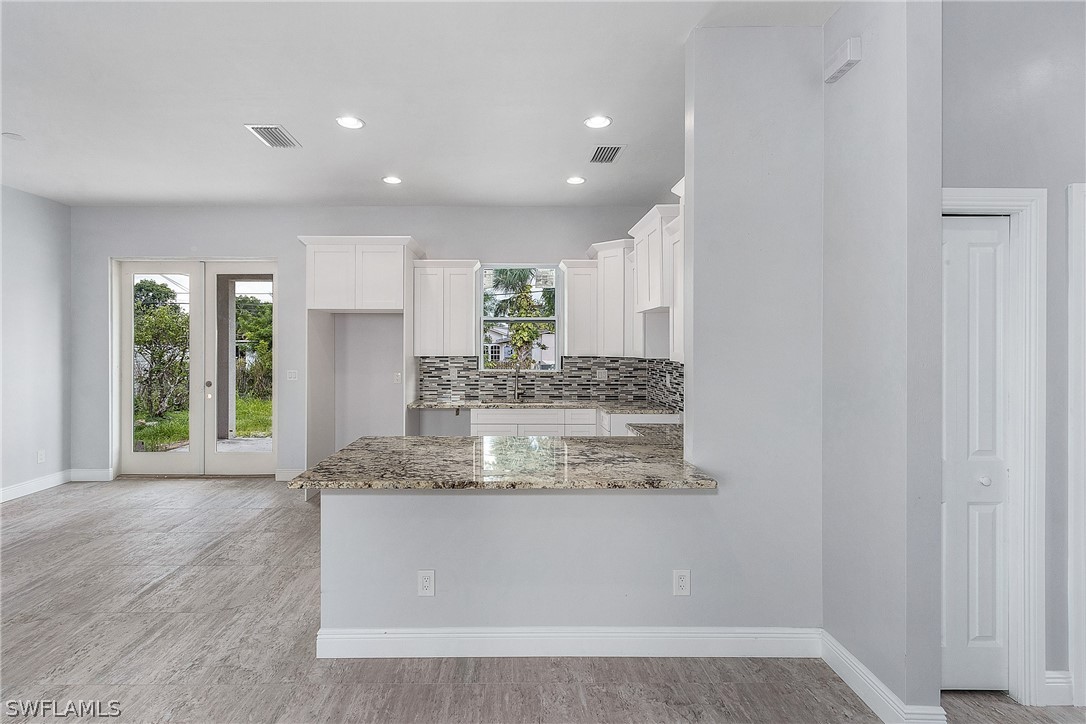 3196 Connecticut Avenue Naples, FL 34112 - Photo 7 of 18 a view of kitchen island a sink wooden floor and a large window